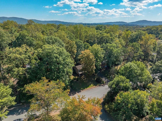 drone / aerial view with a mountain view and a forest view