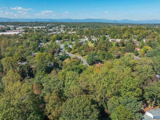 birds eye view of property featuring a mountain view and a wooded view