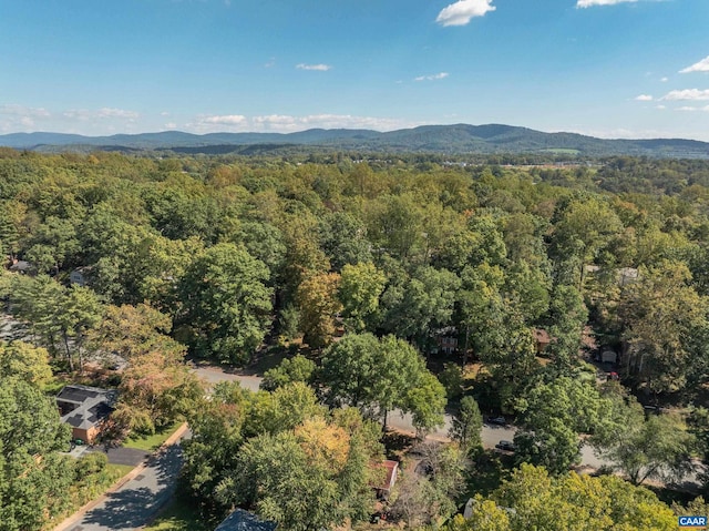 aerial view with a wooded view and a mountain view