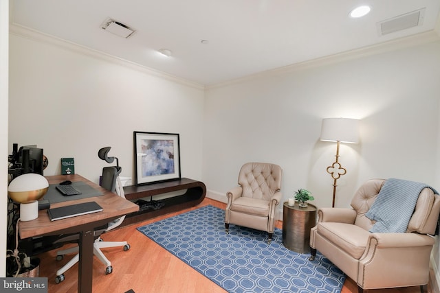 office featuring baseboards, visible vents, ornamental molding, and wood finished floors