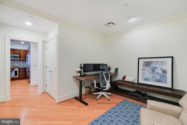 office featuring crown molding, visible vents, and light wood-style floors