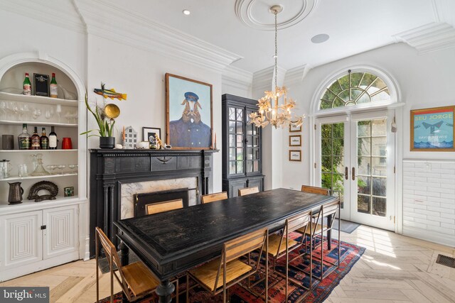 922 Clinton St, Philadelphia, PA 19107 - dining space featuring ornamental molding, french doors, a chandelier, and a fireplace