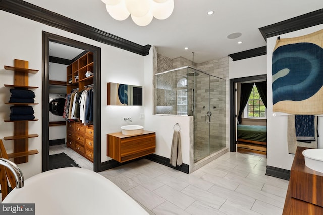 922 Clinton St, Philadelphia, PA 19107 - ensuite bathroom featuring a shower stall, vanity, crown molding, a soaking tub, and baseboards
