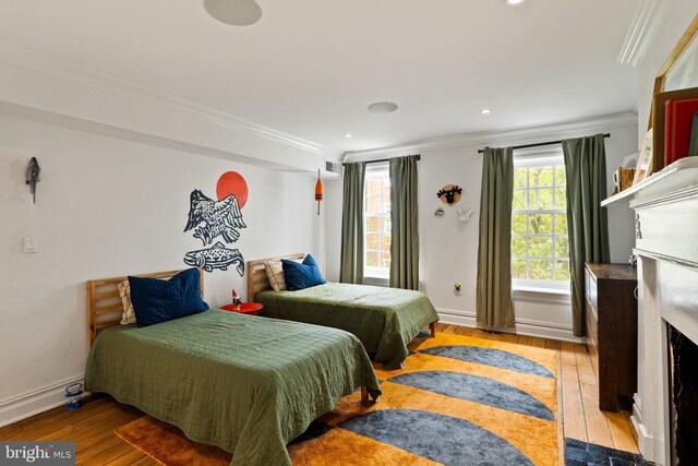 922 Clinton St, Philadelphia, PA 19107 - bedroom featuring ornamental molding, wood-type flooring, baseboards, recessed lighting, and a fireplace with flush hearth