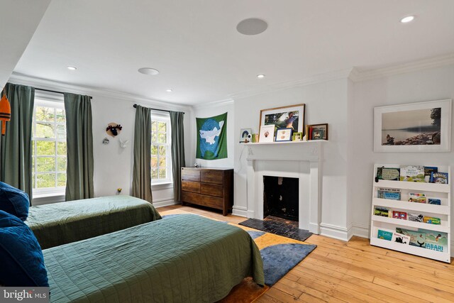 922 Clinton St, Philadelphia, PA 19107 - bedroom with ornamental molding, light wood finished floors, a fireplace with flush hearth, recessed lighting, and baseboards