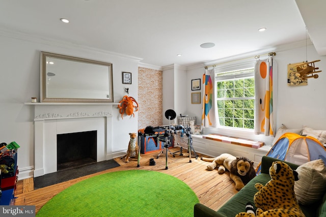922 Clinton St, Philadelphia, PA 19107 - recreation room featuring ornamental molding, wood finished floors, a fireplace with flush hearth, and recessed lighting