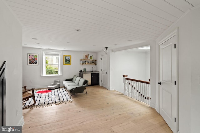 922 Clinton St, Philadelphia, PA 19107 - sitting room featuring light wood-style floors, an upstairs landing, bar, and wooden ceiling