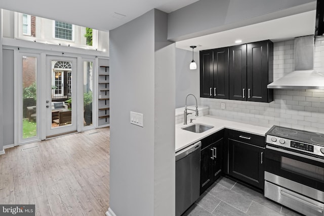 922 Clinton St, Philadelphia, PA 19107 - kitchen with stainless steel appliances, wall chimney exhaust hood, dark cabinets, and a sink
