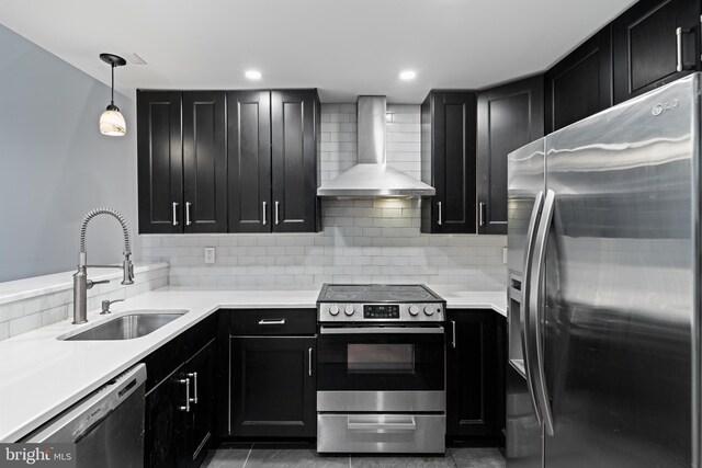 922 Clinton St, Philadelphia, PA 19107 - kitchen featuring stainless steel appliances, wall chimney range hood, and dark cabinetry