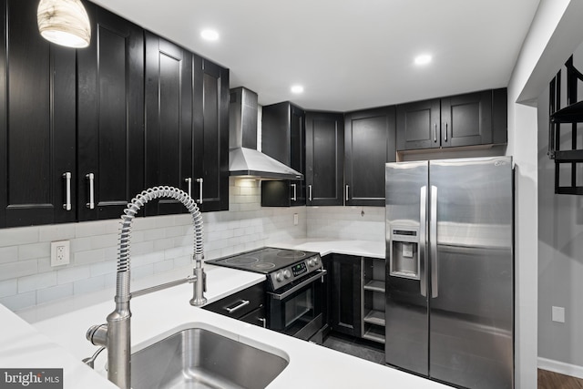 922 Clinton St, Philadelphia, PA 19107 - kitchen with appliances with stainless steel finishes, wall chimney exhaust hood, dark cabinetry, a sink, and light countertops