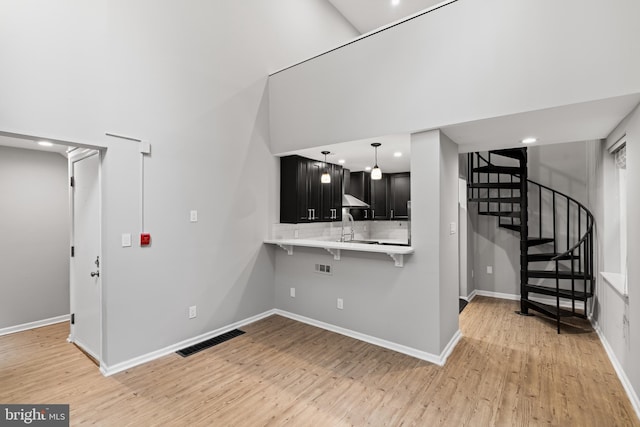 922 Clinton St, Philadelphia, PA 19107 - unfurnished living room featuring light wood-type flooring, baseboards, stairs, recessed lighting, and a sink