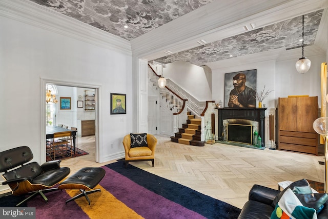 922 Clinton St, Philadelphia, PA 19107 - living room with a fireplace with flush hearth, stairs, a towering ceiling, crown molding, and baseboards