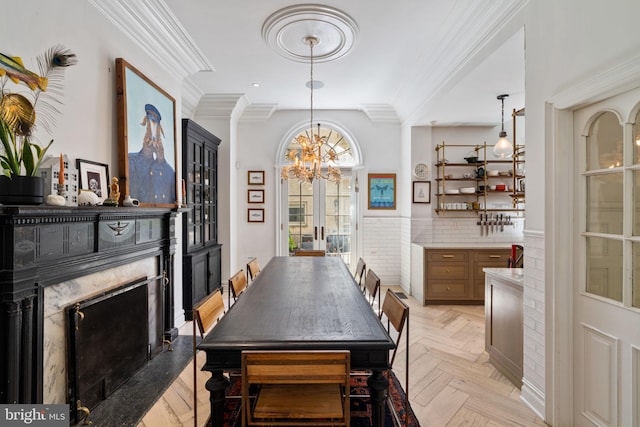 922 Clinton St, Philadelphia, PA 19107 - dining area with ornamental molding, a chandelier, and a high end fireplace
