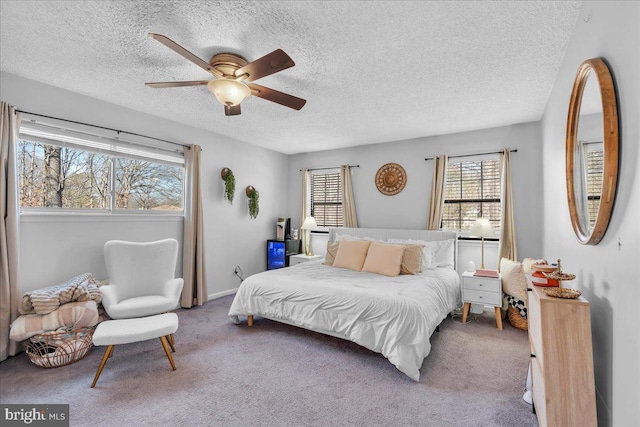 bedroom with ceiling fan, a textured ceiling, and light colored carpet