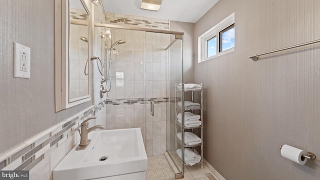 full bathroom with a sink and a shower stall