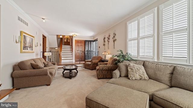 living room with light carpet, stairway, visible vents, and crown molding