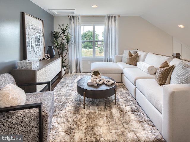 living room featuring vaulted ceiling and recessed lighting