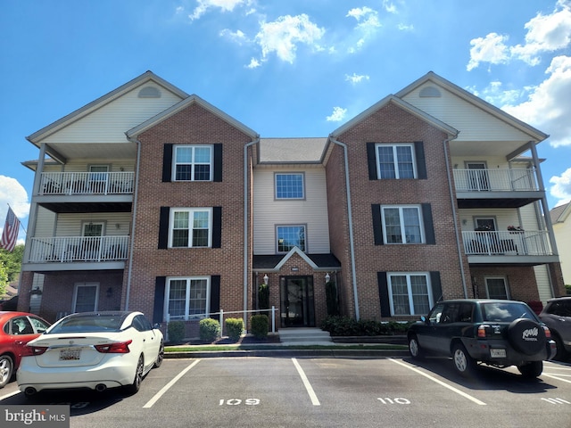 view of building exterior featuring uncovered parking