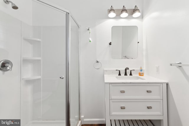 full bathroom featuring a shower stall and vanity