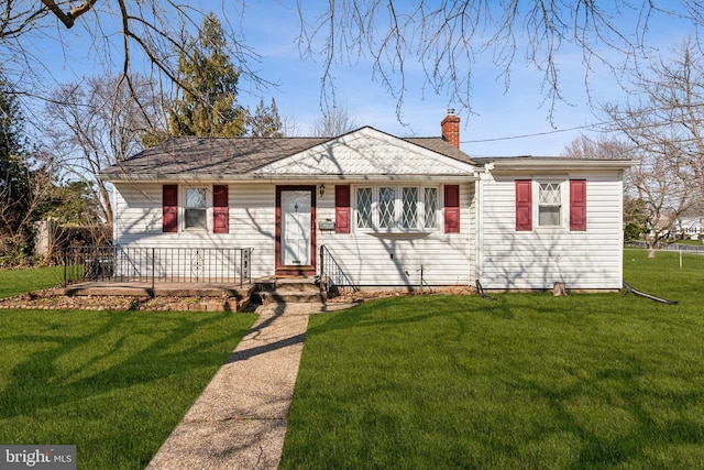 single story home featuring a front lawn and a chimney