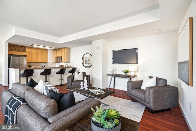 living area with dark wood-style floors and baseboards