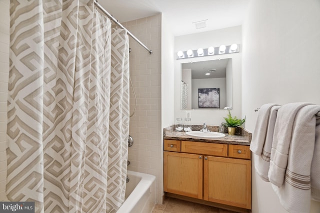 full bathroom with shower / tub combo, tile patterned floors, and vanity