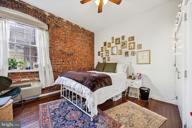 bedroom with brick wall, wood-type flooring, and a ceiling fan