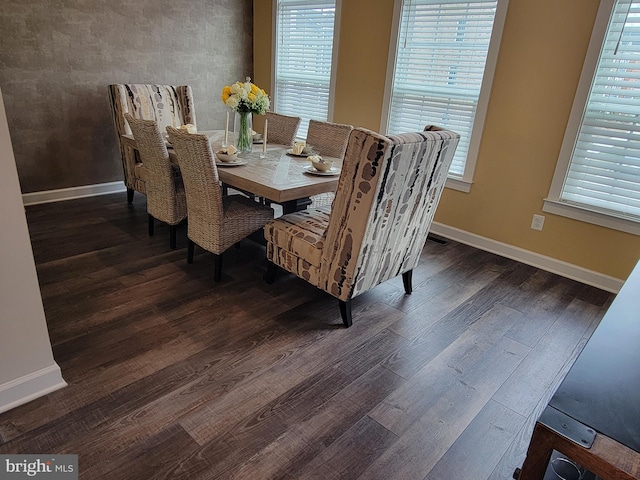 dining room featuring dark wood-type flooring and baseboards