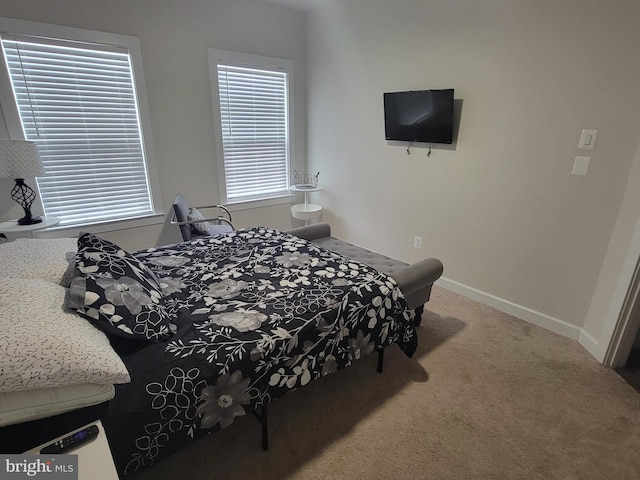 carpeted bedroom featuring baseboards