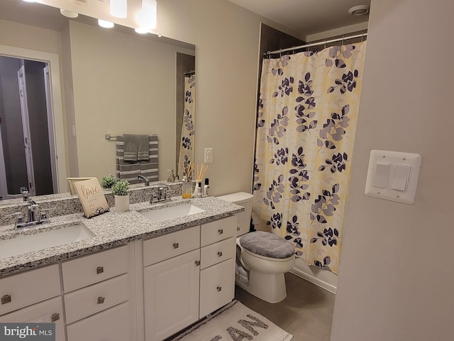 full bath with toilet, double vanity, a sink, and a shower with shower curtain