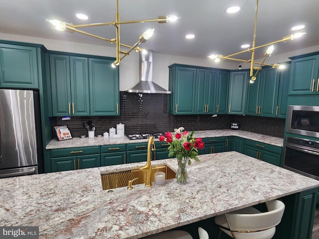 kitchen featuring a breakfast bar area, appliances with stainless steel finishes, wall chimney exhaust hood, tasteful backsplash, and pendant lighting