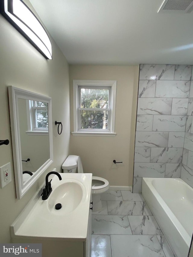 bathroom with toilet, visible vents, vanity, baseboards, and marble finish floor