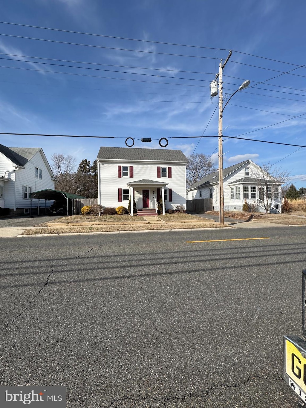 view of front of home featuring a carport and fence