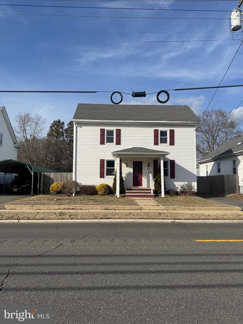 traditional-style home with fence