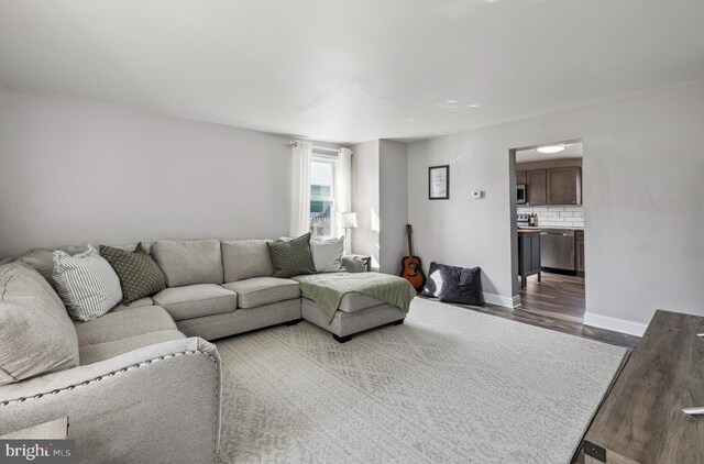 living room featuring wood finished floors and baseboards