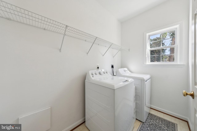 washroom featuring laundry area, independent washer and dryer, and baseboards