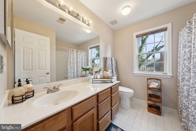 bathroom featuring baseboards, vanity, visible vents, and tile patterned floors