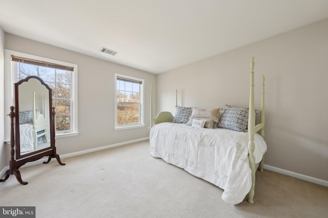 carpeted bedroom featuring visible vents and baseboards