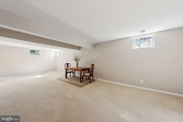 dining room featuring visible vents, light carpet, and baseboards