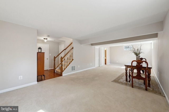 interior space with visible vents, stairway, and baseboards