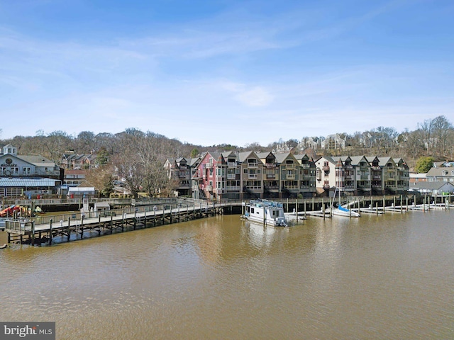 view of dock featuring a water view and a residential view