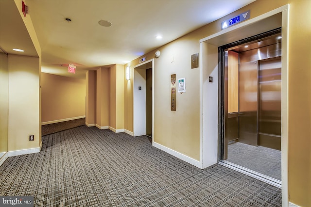 corridor with carpet floors, recessed lighting, elevator, and baseboards