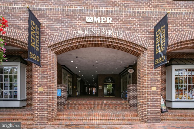 view of exterior entry featuring brick siding