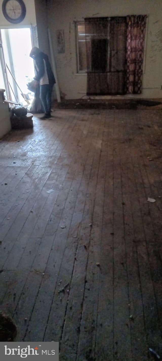 unfurnished living room featuring wood finished floors