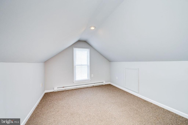 bonus room featuring vaulted ceiling, baseboard heating, carpet, and baseboards