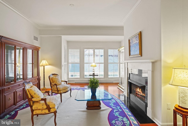 living area with a wealth of natural light, visible vents, a fireplace with flush hearth, and ornamental molding