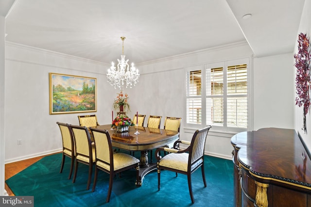 dining area featuring ornamental molding, baseboards, and a chandelier