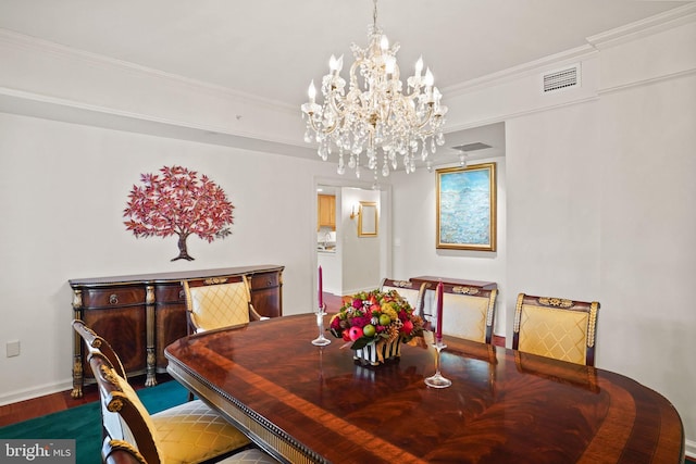 dining area featuring visible vents, baseboards, ornamental molding, wood finished floors, and a notable chandelier