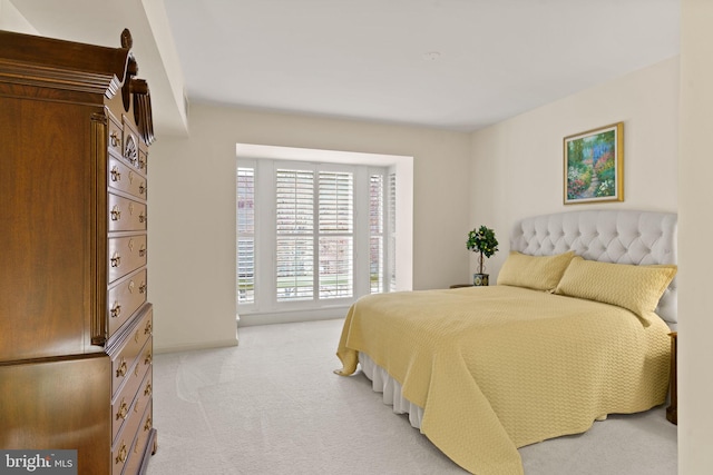 bedroom featuring light carpet