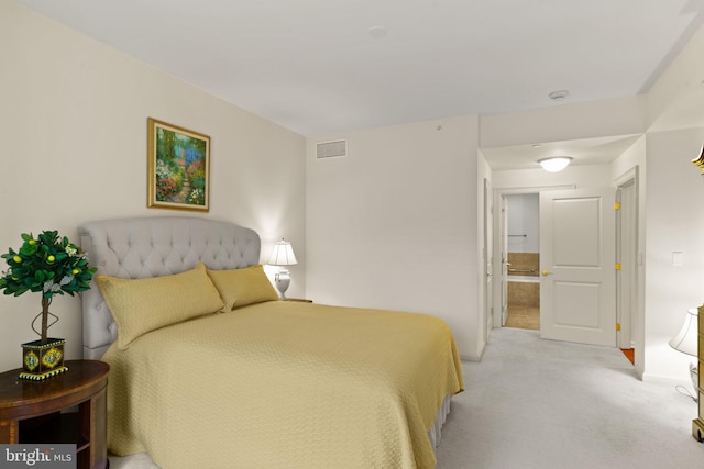 bedroom featuring baseboards, visible vents, and light carpet